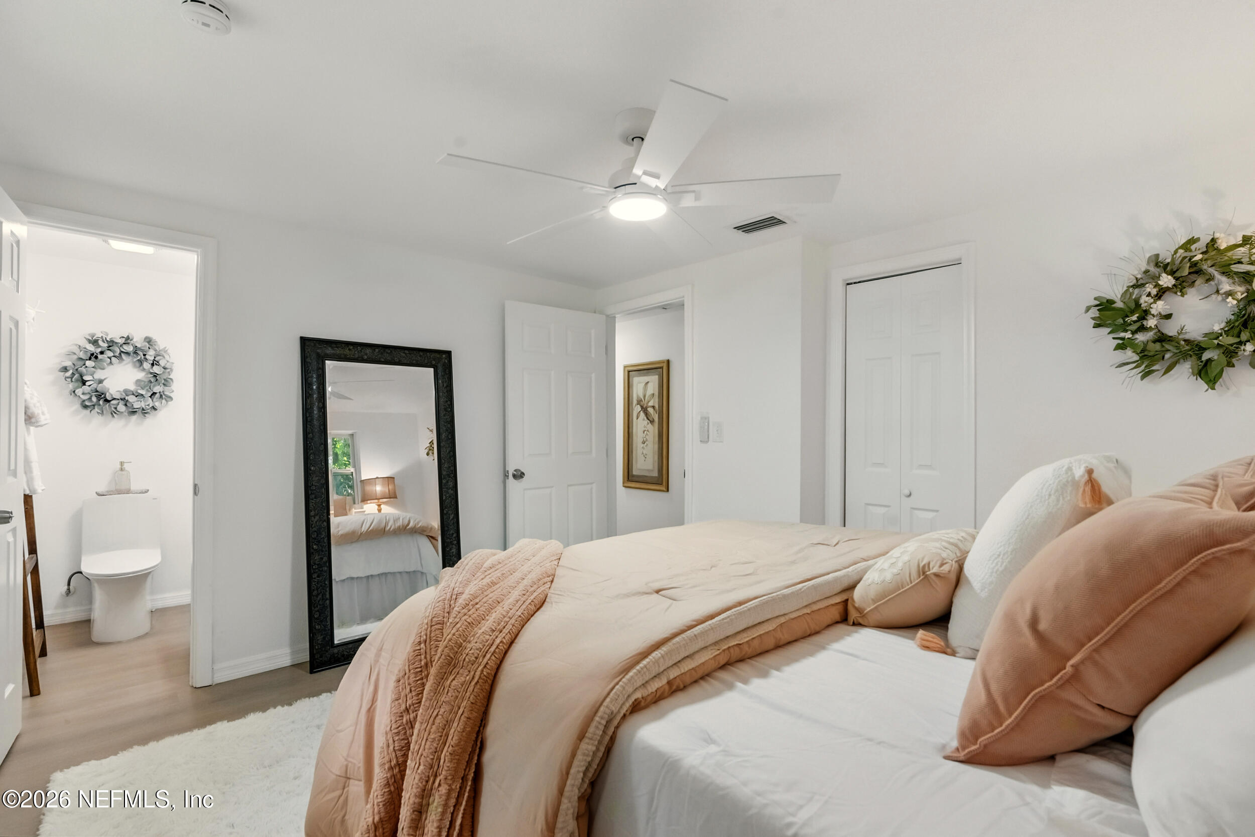 3530 Shadow Street Jacksonville, FL 32254 - Photo 6 of 32 a bedroom with a large bed and a chandelier