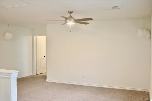 a bedroom with a bed and two mirror