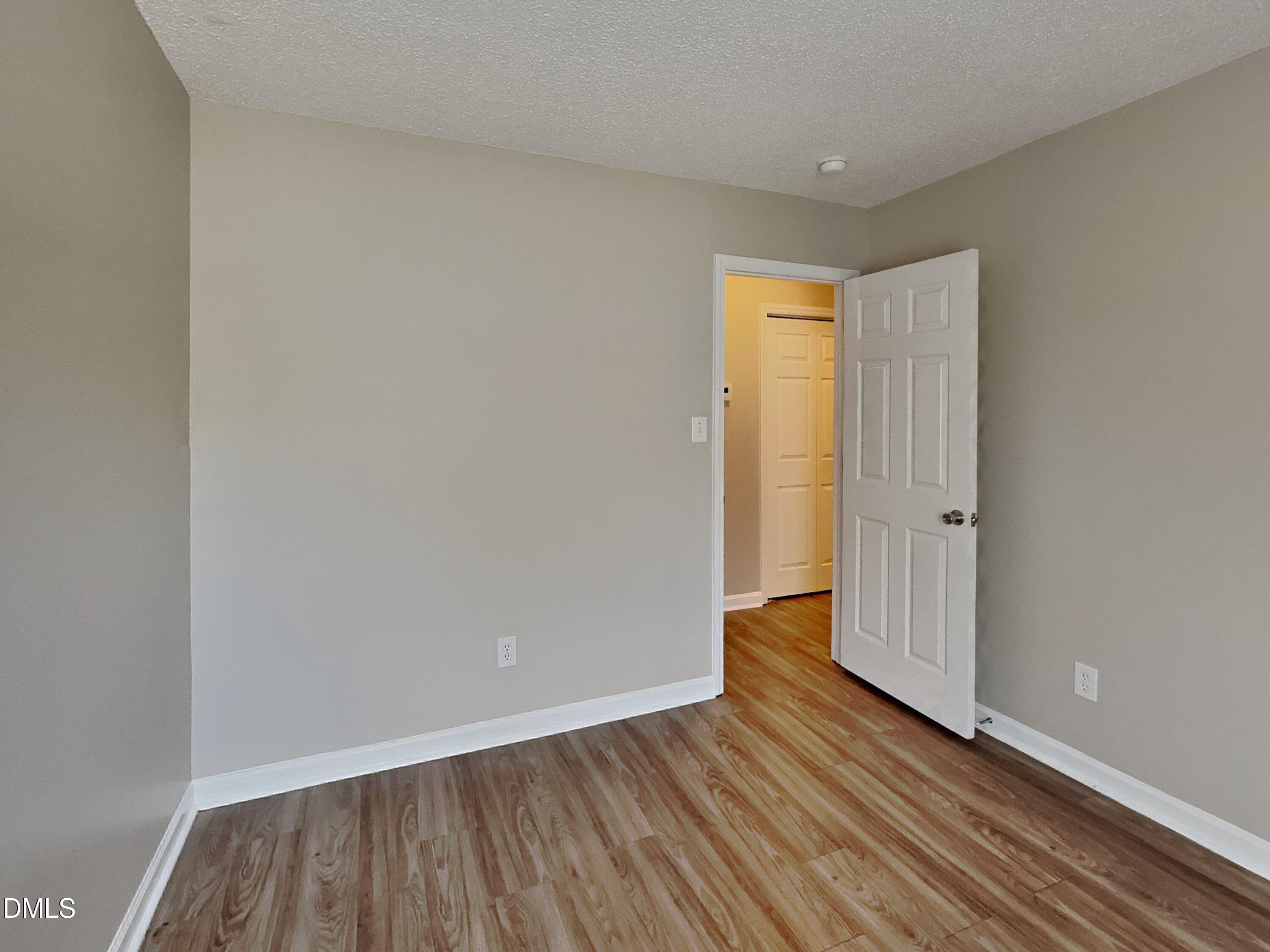 5516 Wilhagan Court Raleigh, NC 27616 - Photo 13 of 16 a view of an empty room with wooden floor