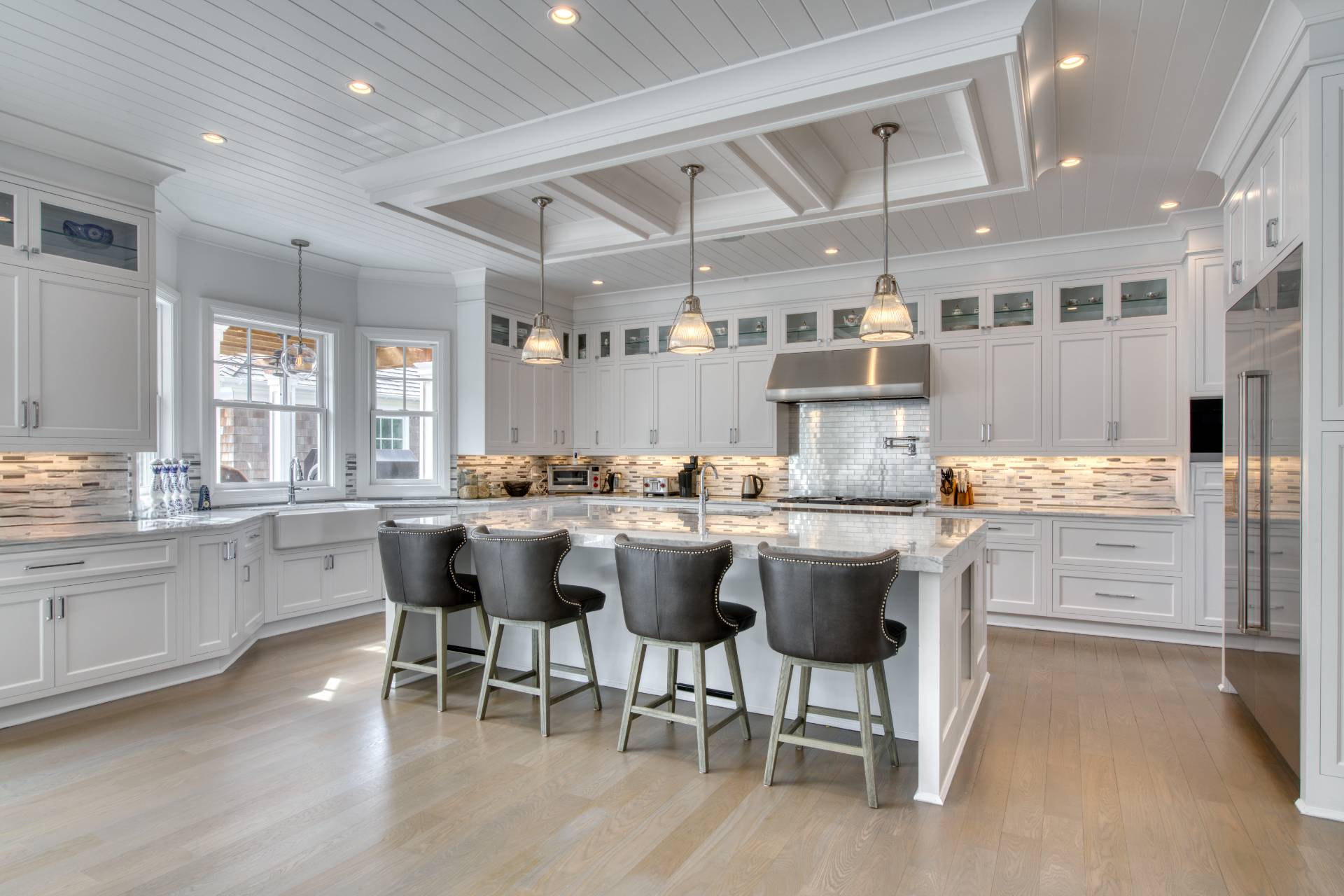 134 Hills Station Road Southampton, NY 11968 - Photo 5 of 33 a dining room with stainless steel appliances kitchen island granite countertop a table chairs and a sink