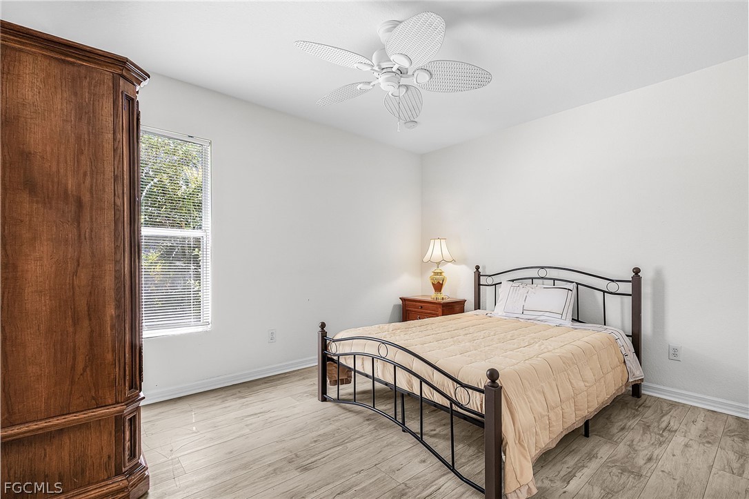 3852 Stabile Road St. James City, FL 33956 - Photo 12 of 27 a bedroom with a bed and a window
