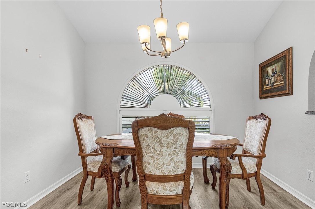 3852 Stabile Road St. James City, FL 33956 - Photo 14 of 27 a view of a dining room with furniture and wooden floor