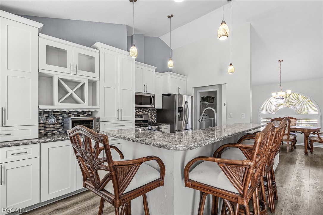 3852 Stabile Road St. James City, FL 33956 - Photo 15 of 27 a dining room with furniture and chandelier