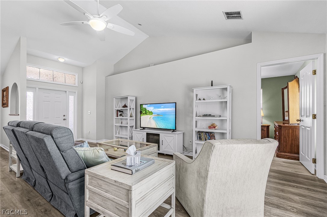 3852 Stabile Road St. James City, FL 33956 - Photo 16 of 27 a living room with furniture a wooden floor and a ceiling fan
