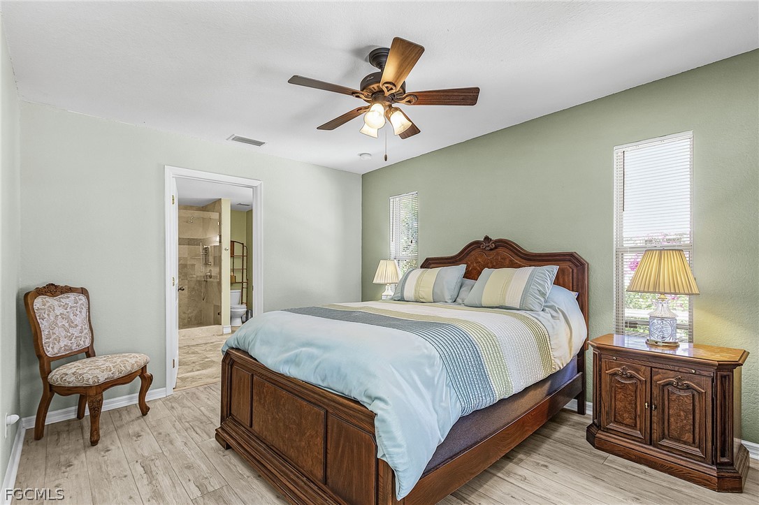 3852 Stabile Road St. James City, FL 33956 - Photo 17 of 27 a bedroom with a bed and chair