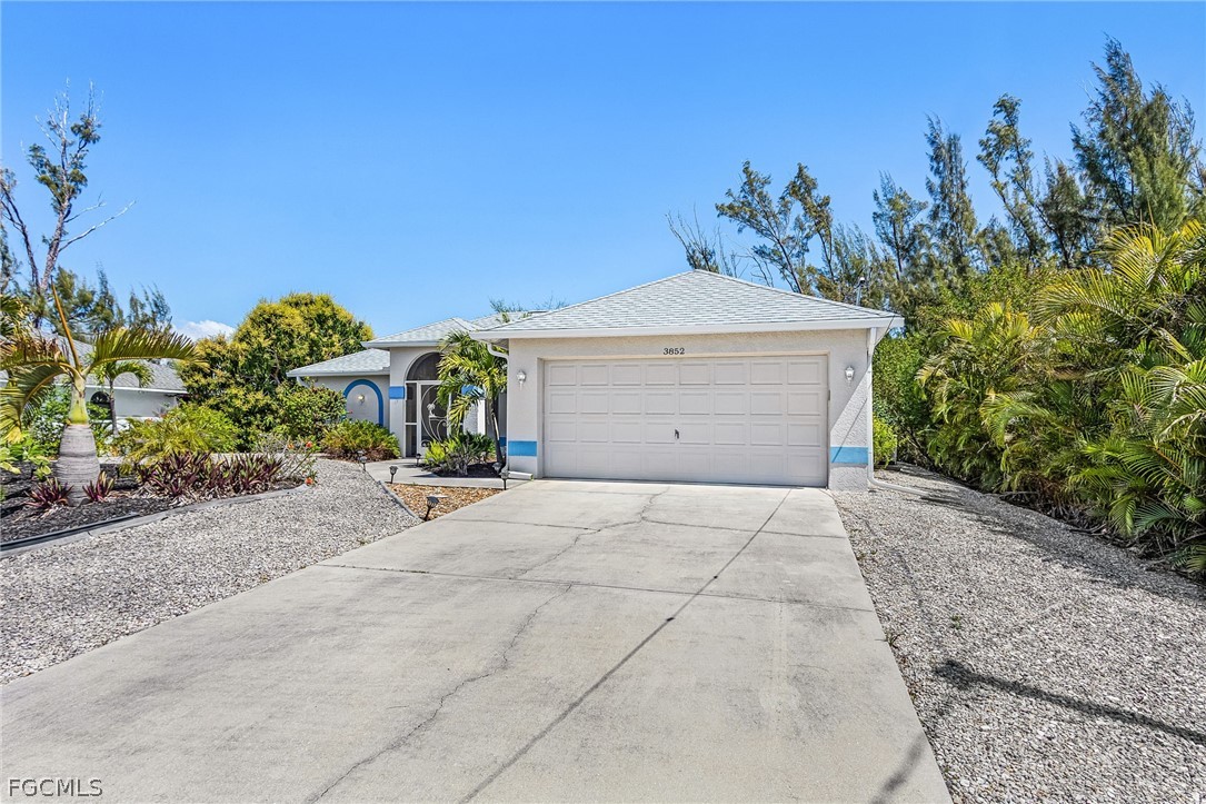 3852 Stabile Road St. James City, FL 33956 - Photo 3 of 27 a view of a house with a yard and a garage