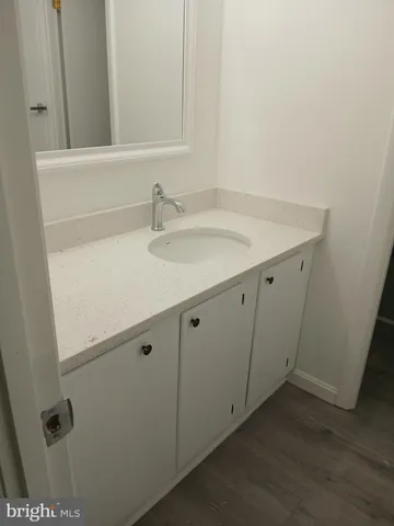 a bathroom with a sink and mirror