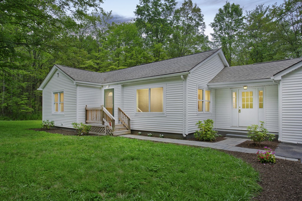 141 Maxwell Road Monson, MA 01057 - Photo 3 of 22 a front view of a house with a garden and plants