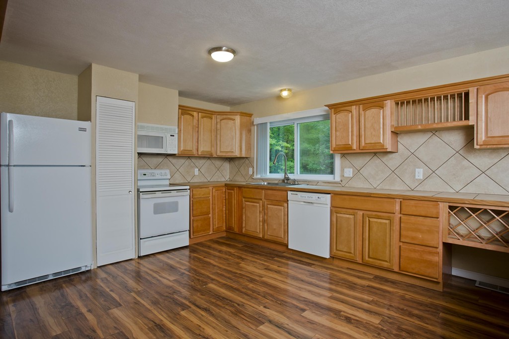 141 Maxwell Road Monson, MA 01057 - Photo 6 of 22 a kitchen with granite countertop white cabinets and white appliances