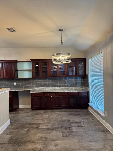 a large kitchen with kitchen island a sink stainless steel appliances and cabinets