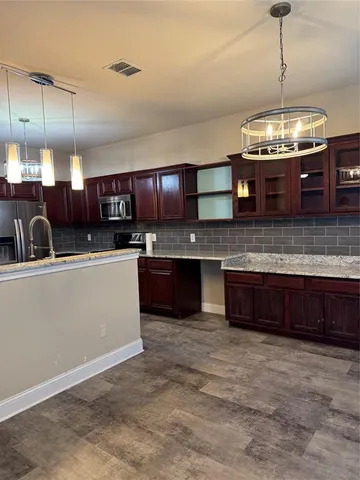 a kitchen with stainless steel appliances granite countertop a sink and a counter top space