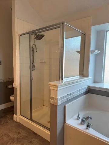 a bathroom with a bathtub and a shower