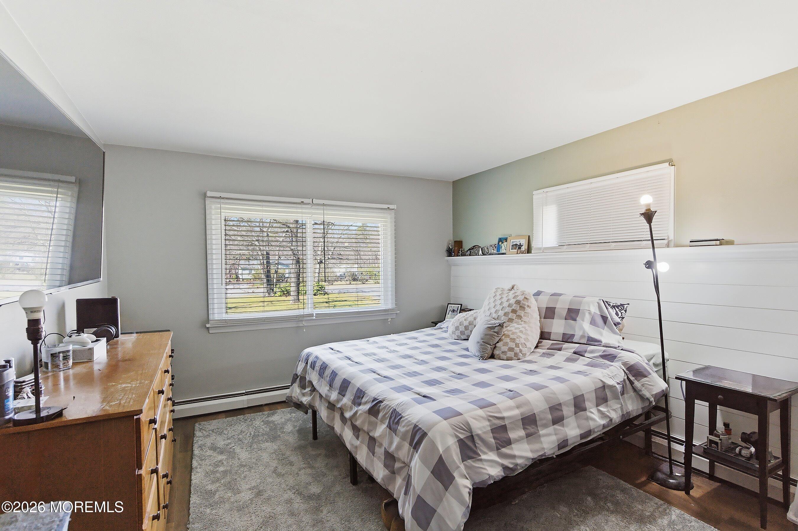 745 Oak Glen Road Howell, NJ 07731 - Photo 20 of 46 a bedroom with a bed table chair and a window