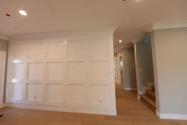 an empty room with a windows and chandelier