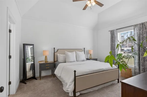 a bedroom with a bed table and a chandelier