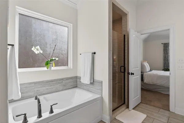 a bathroom with a tub and a shower