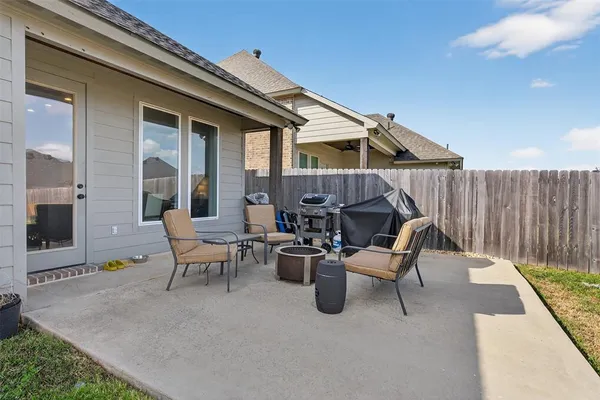 a view of a patio with a chairs and table in a patio