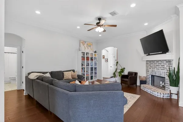 a living room with fireplace furniture and a flat screen tv