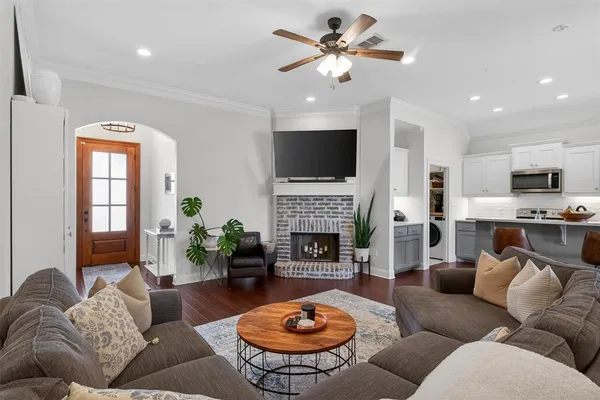 a living room with furniture a fireplace and a flat screen tv