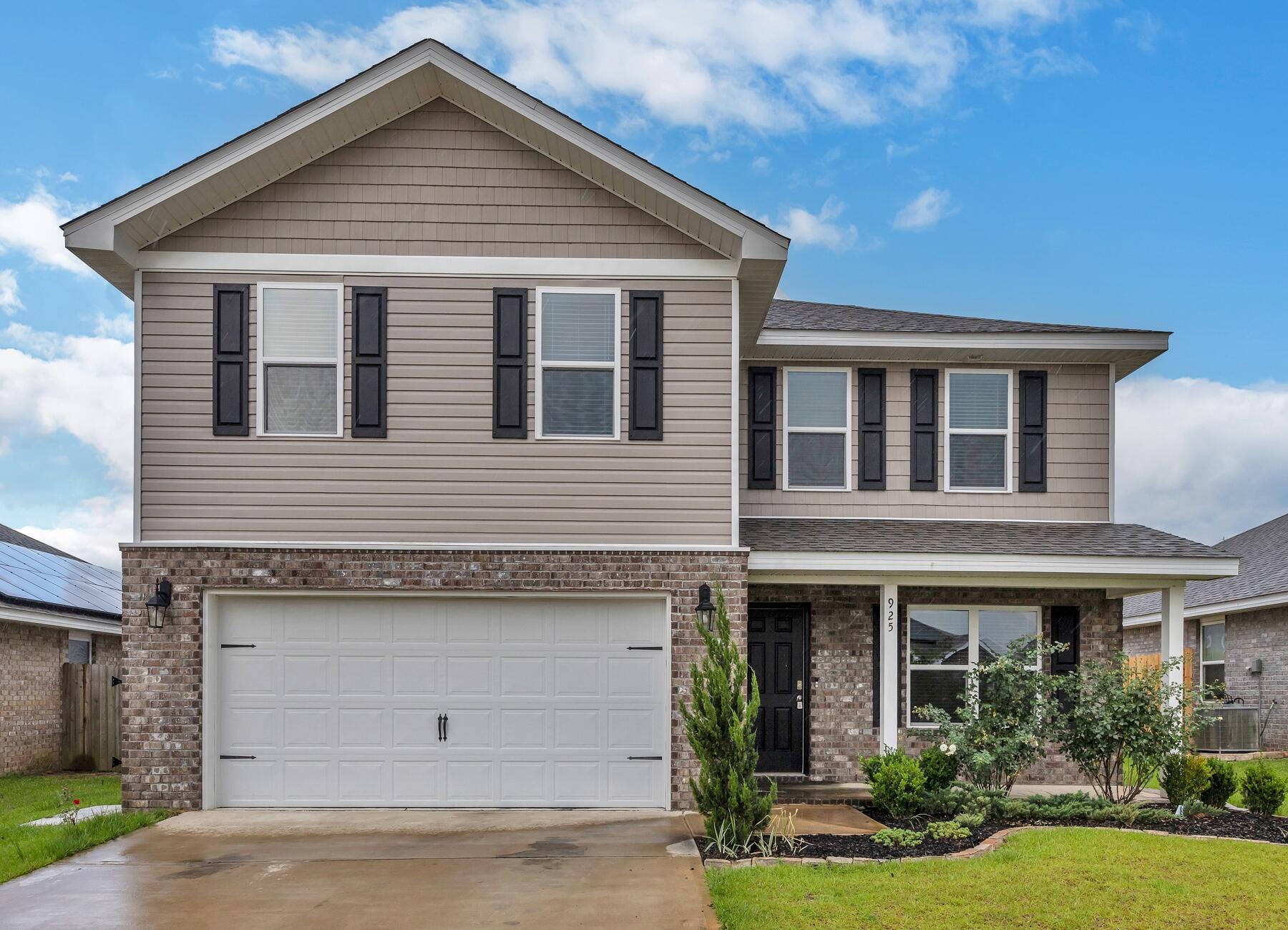 a front view of a house with garden