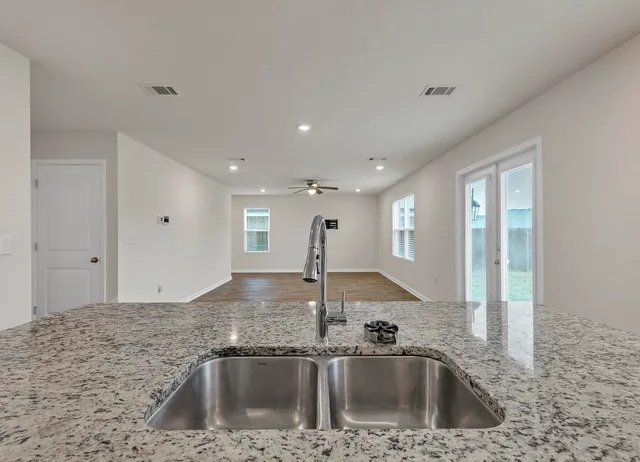 a kitchen with a sink and a refrigerator