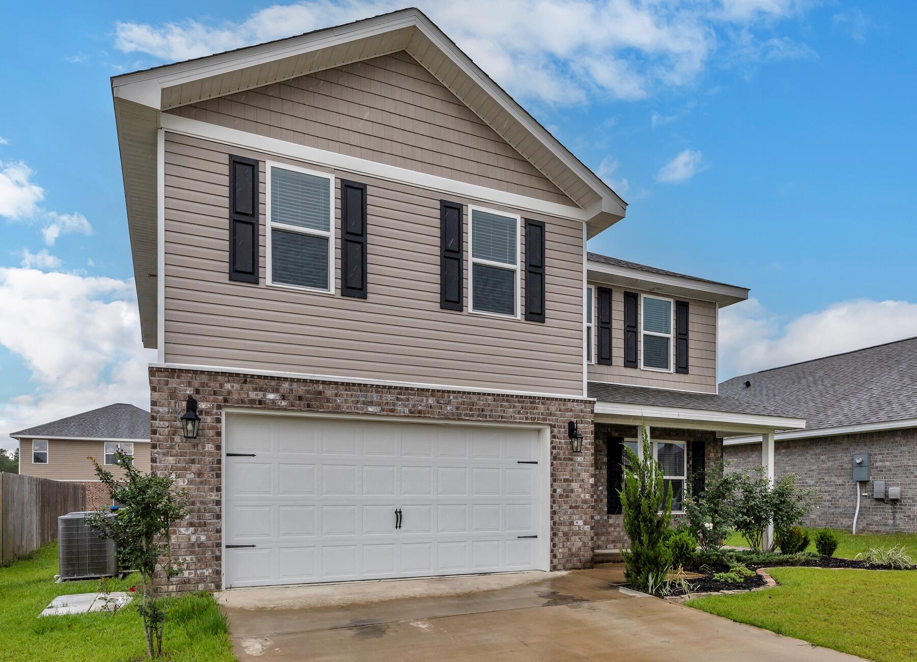 925 Merganser Way Crestview, FL 32539 - Photo 2 of 37 a front view of a house with garden