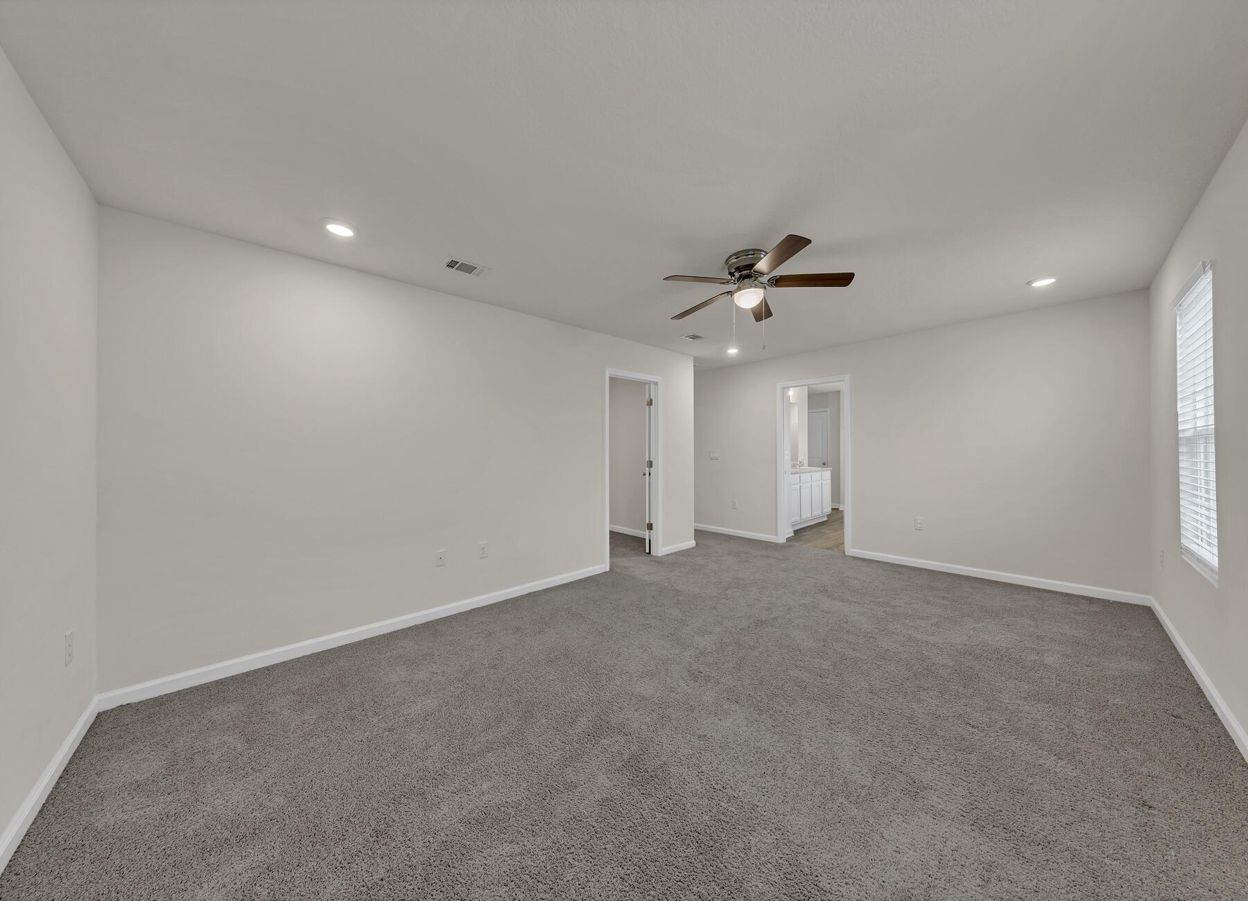 925 Merganser Way Crestview, FL 32539 - Photo 21 of 37 a view of an empty room with a ceiling fan