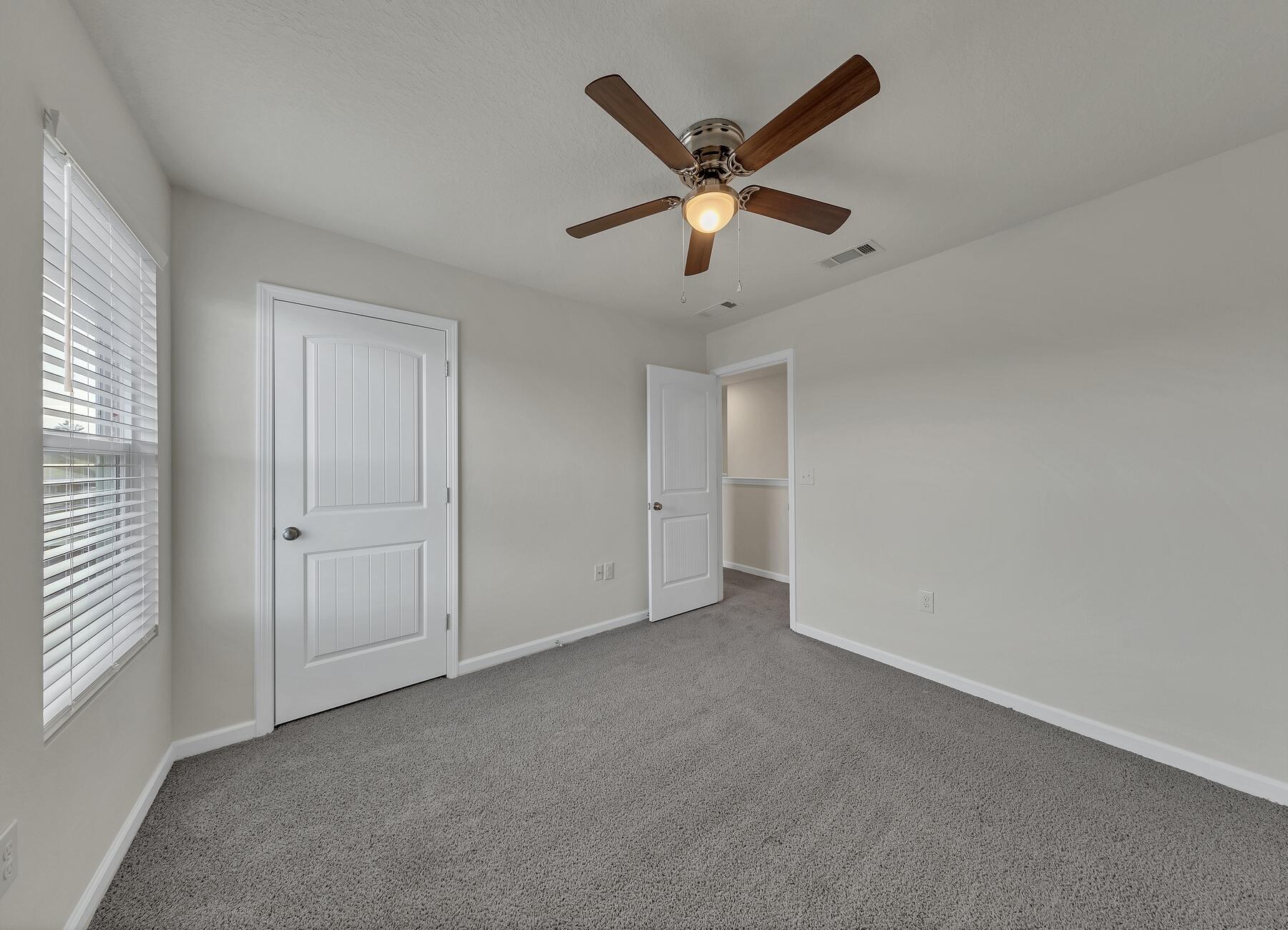 925 Merganser Way Crestview, FL 32539 - Photo 35 of 37 an empty room with windows and fan