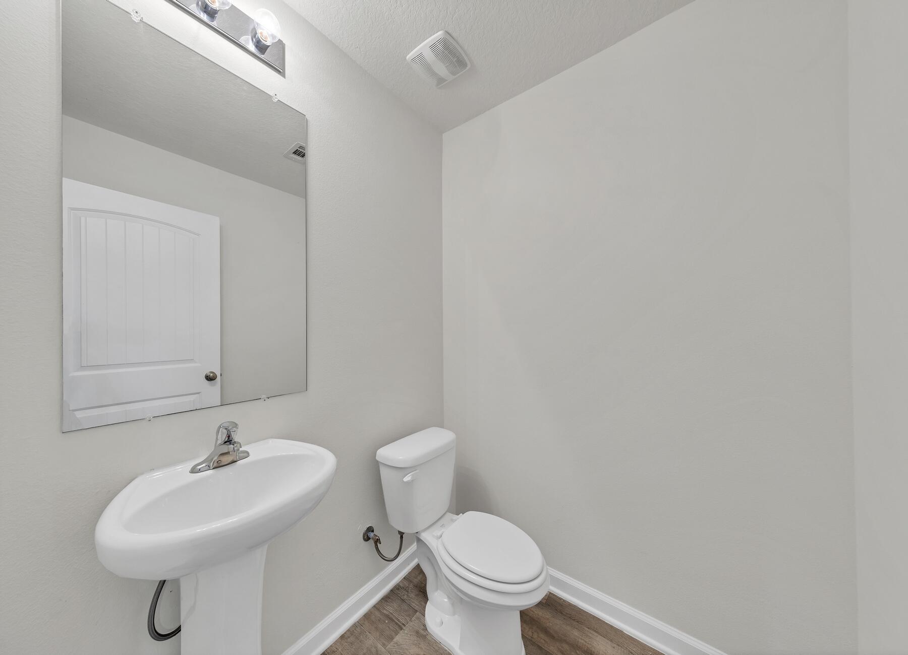 925 Merganser Way Crestview, FL 32539 - Photo 8 of 37 a bathroom with a sink a toilet and a mirror