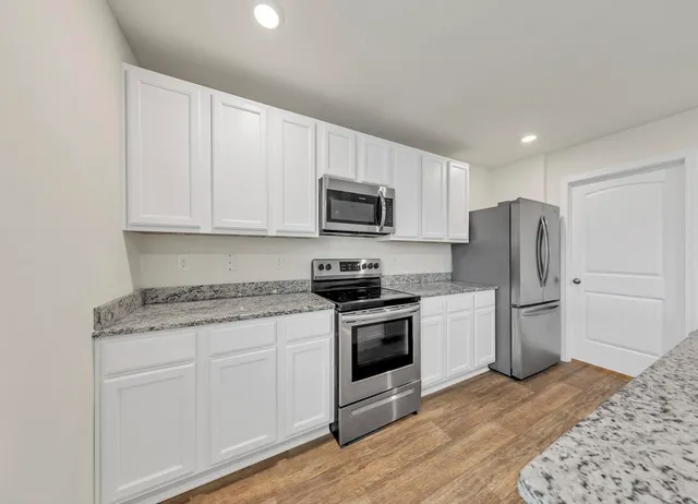 a kitchen with a sink stove and refrigerator