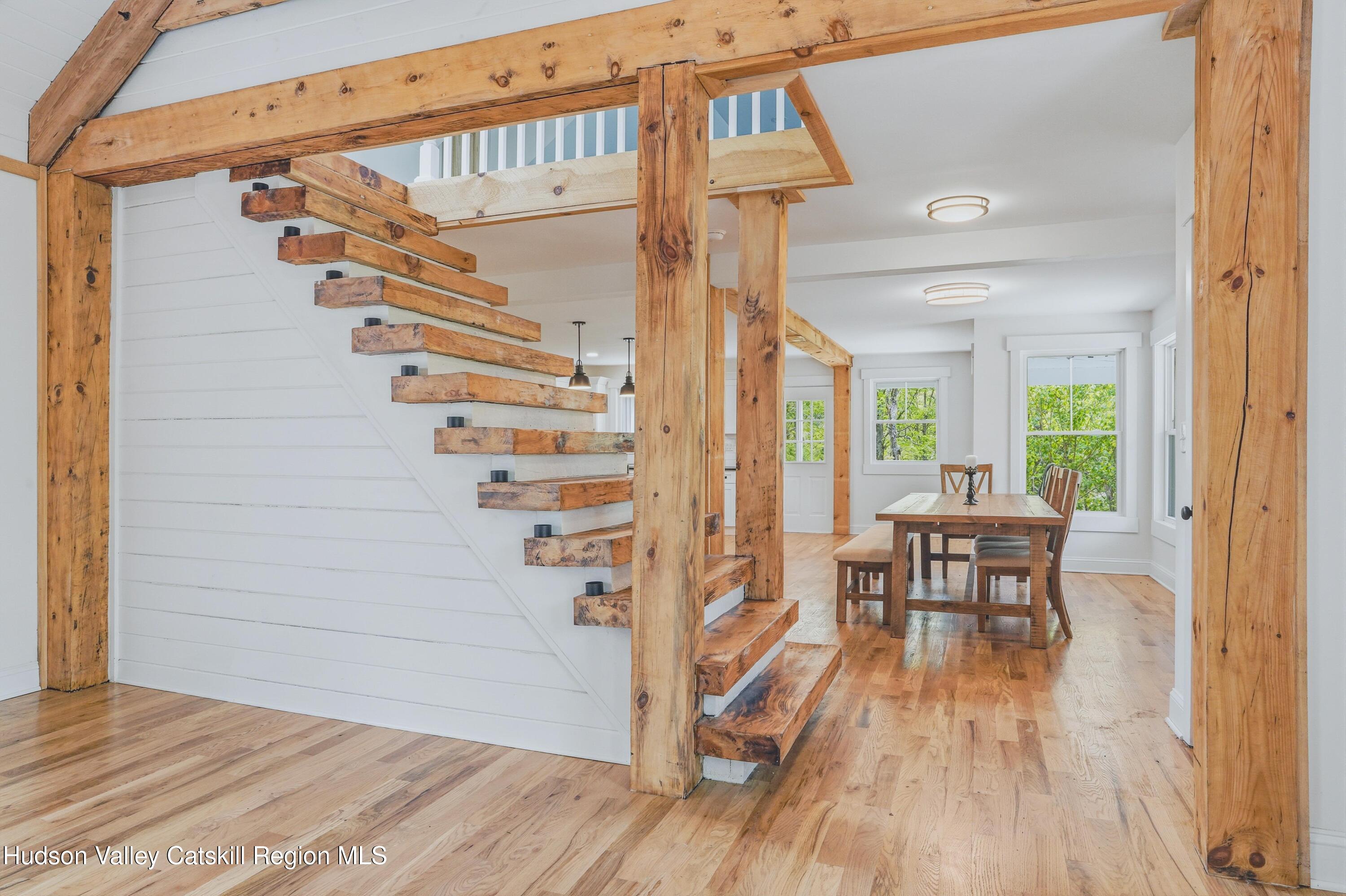 757 Taborton Road Sand Lake, NY 12153 - Photo 6 of 32 a view of a hallway with wooden floor and a dining room