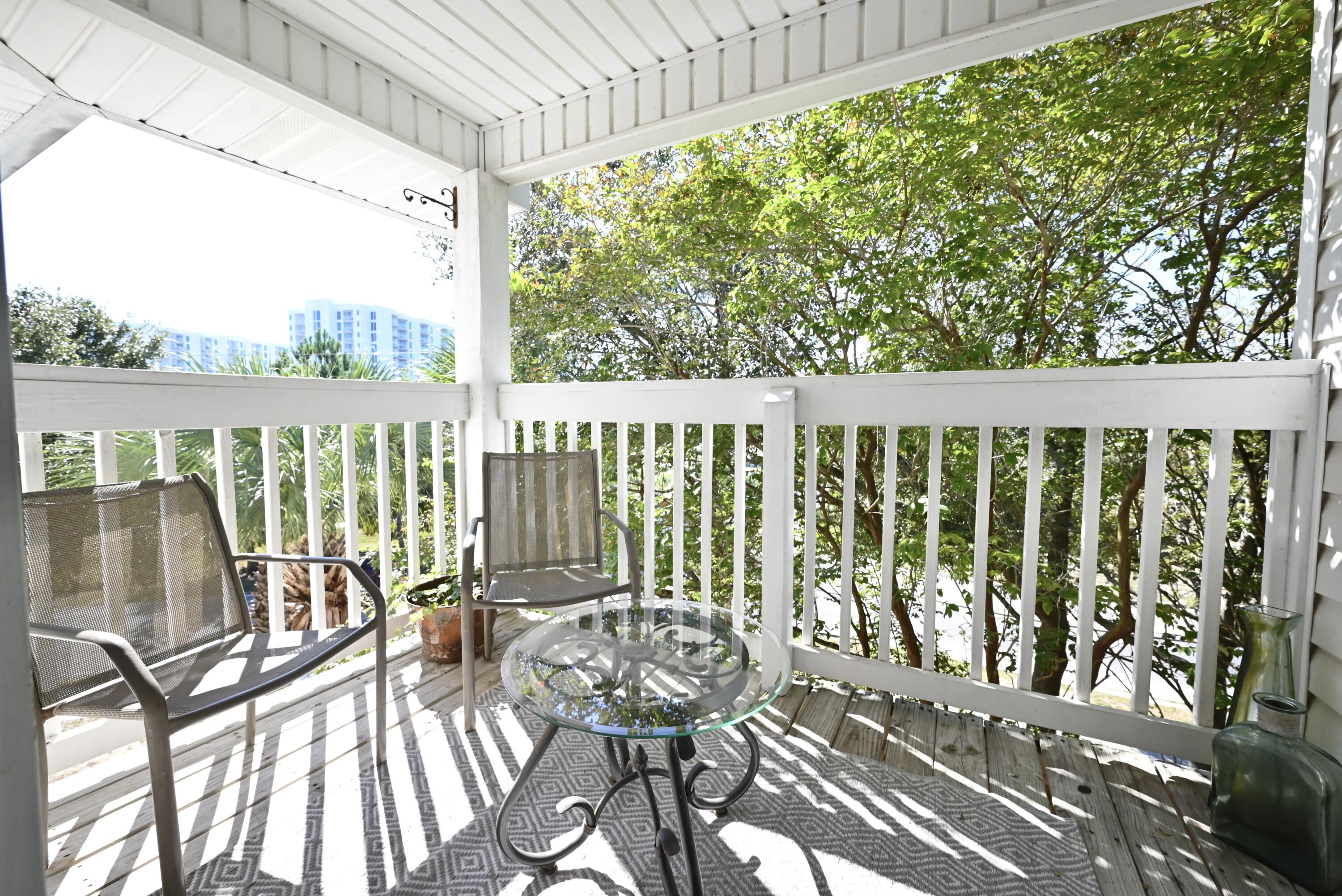 a view of balcony with wooden floor and outdoor seating