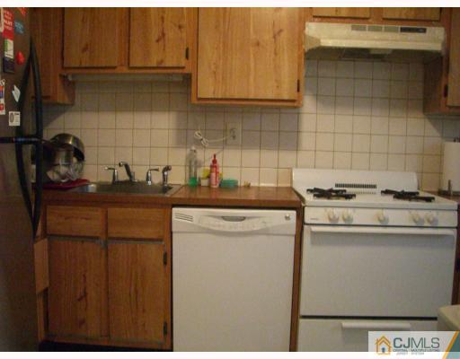 1902 Raspberry Court Edison, NJ 08817 - Photo 5 of 6 a kitchen with stainless steel appliances granite countertop a sink stove and cabinets