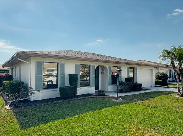 a view of a house with a backyard and a patio