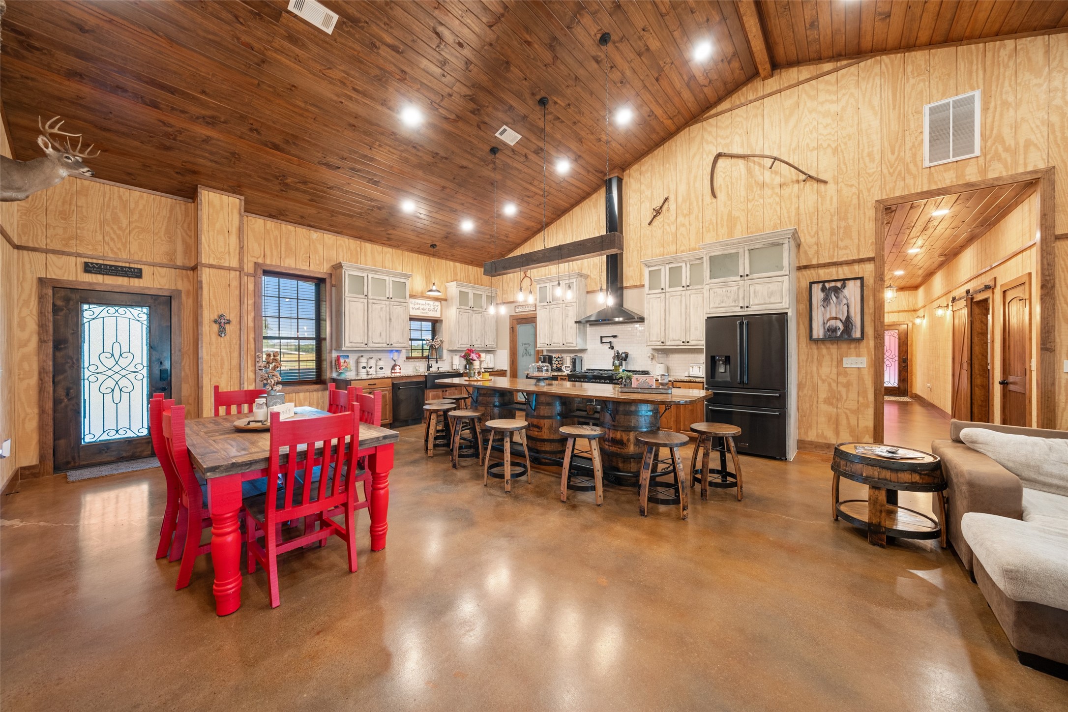 1402 Eagle Ferry Road Anahuac, TX 77514 - Photo 24 of 48 Open sightlines from the kitchen to the stone fireplace in the living room, with energy-efficient closed-cell spray foam insulation keeping temperatures consistent year-round.
