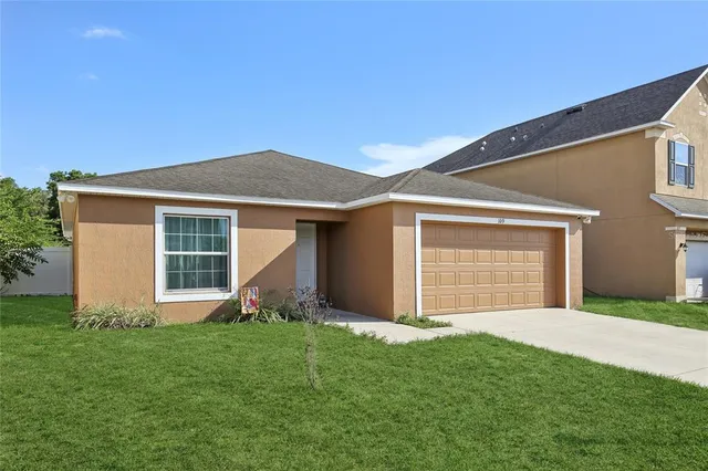 a front view of house with a garden and yard