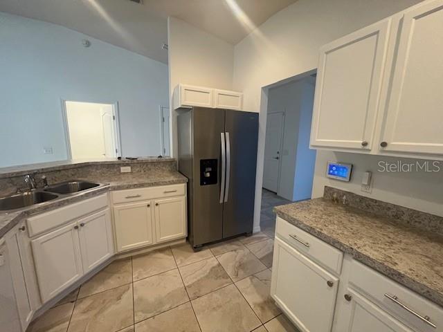 109 James Circle Lake Alfred, FL 33850 - Photo 12 of 17 a kitchen with a sink refrigerator and microwave