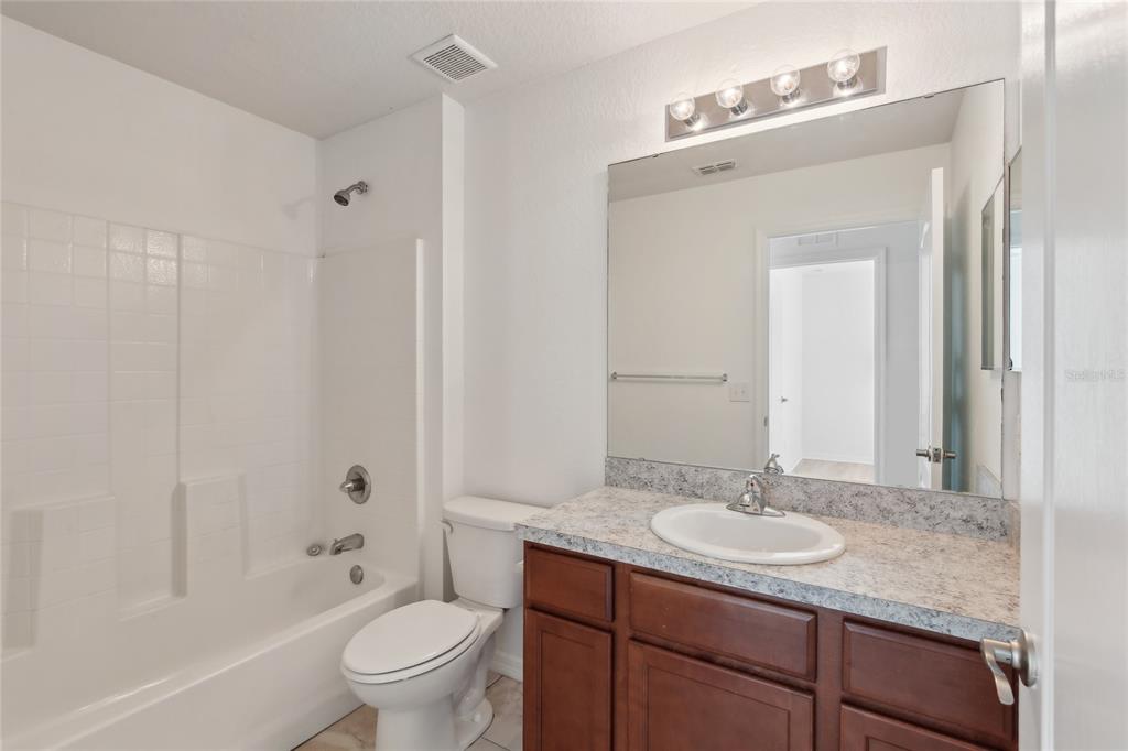 109 James Circle Lake Alfred, FL 33850 - Photo 13 of 17 a bathroom with a granite countertop sink toilet and shower