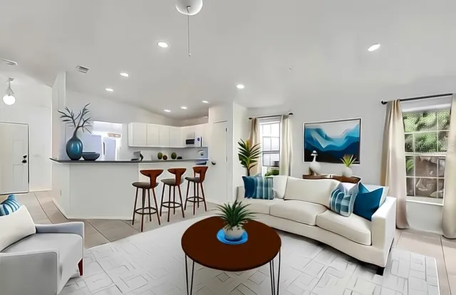 a living room with furniture and a view of kitchen