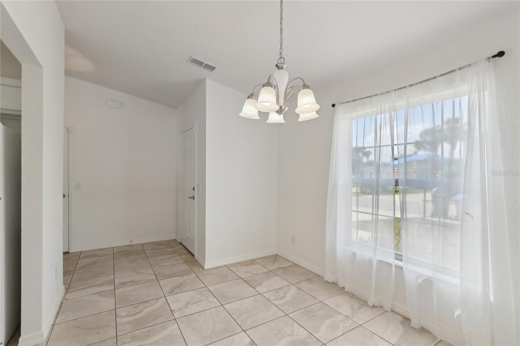 109 James Circle Lake Alfred, FL 33850 - Photo 7 of 17 a view of a livingroom with a chandelier fan and windows