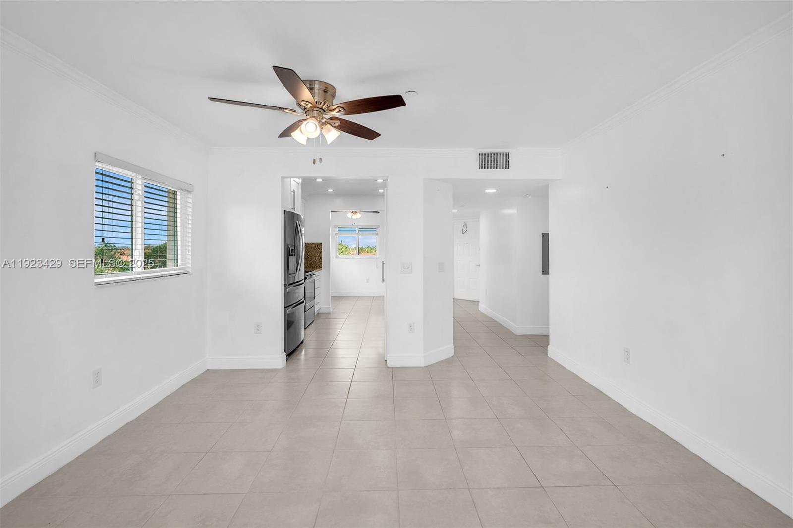 701 Southwest 142nd Avenue, Unit 414S Pembroke Pines, FL 33027 - Photo 15 of 30 a view of empty room with wooden floor and ceiling fan