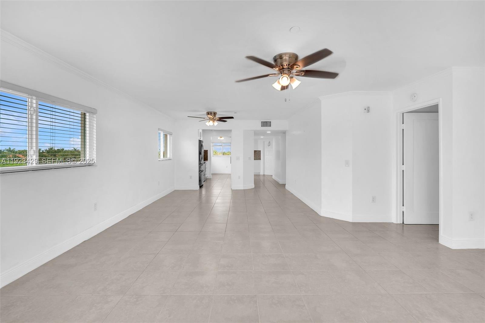 701 Southwest 142nd Avenue, Unit 414S Pembroke Pines, FL 33027 - Photo 17 of 30 a view of empty room with wooden floor and ceiling fan