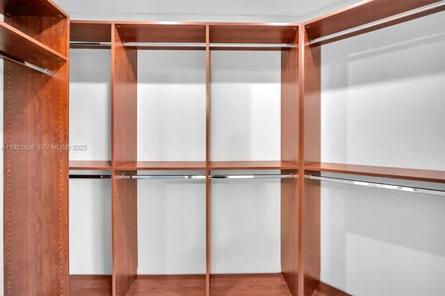 a view of walk in closet with empty racks
