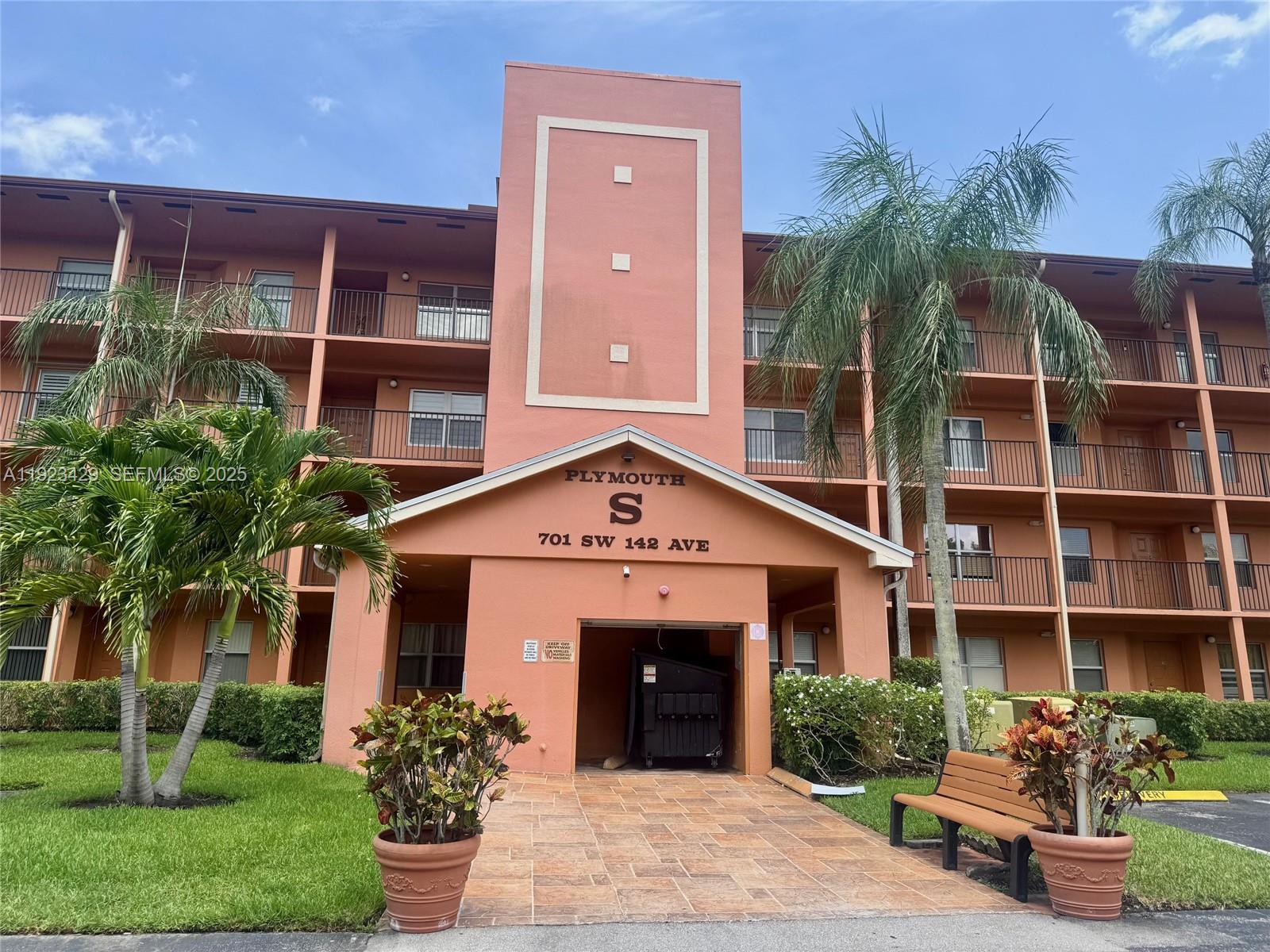 701 Southwest 142nd Avenue, Unit 414S Pembroke Pines, FL 33027 - Photo 2 of 30 a front view of a house with a garden and plants