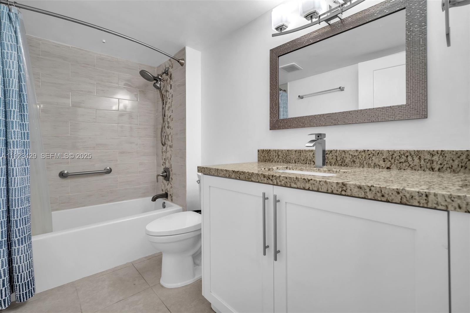 701 Southwest 142nd Avenue, Unit 414S Pembroke Pines, FL 33027 - Photo 22 of 30 a bathroom with a granite countertop sink a toilet and shower