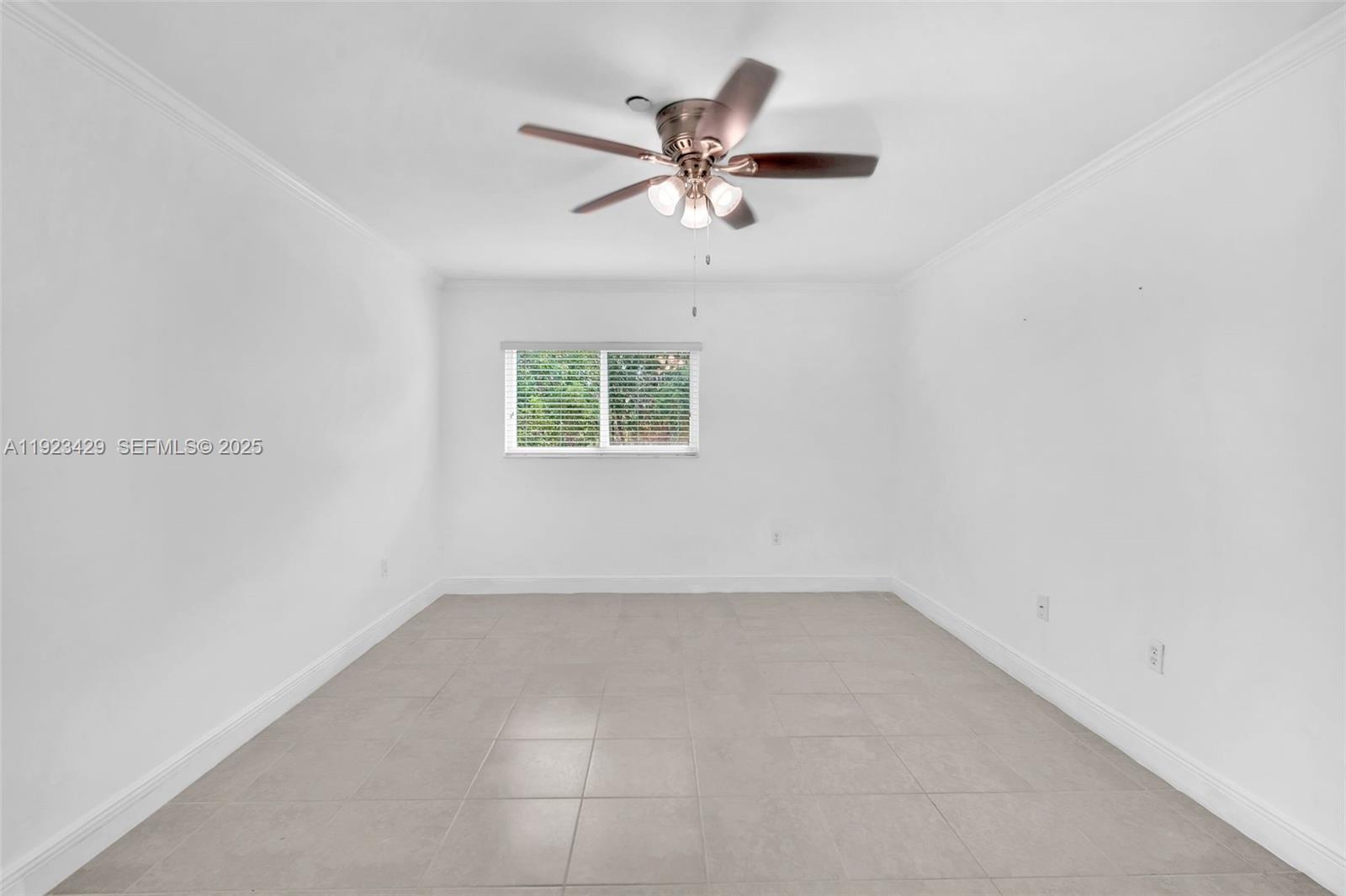 701 Southwest 142nd Avenue, Unit 414S Pembroke Pines, FL 33027 - Photo 23 of 30 an empty room with a window and a ceiling fan