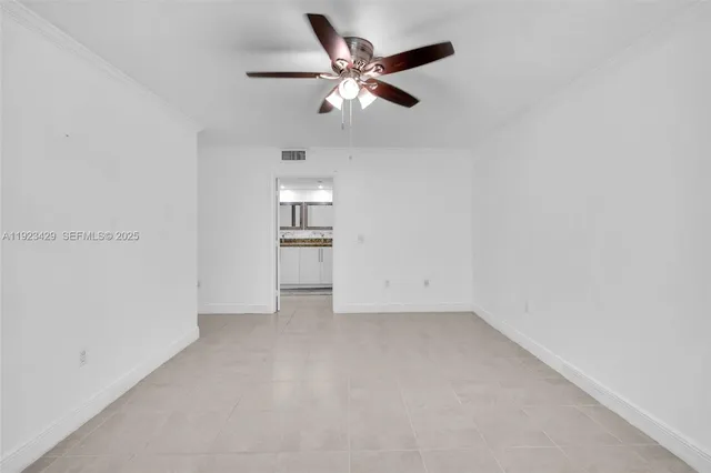 an empty room with closet and ceiling fan