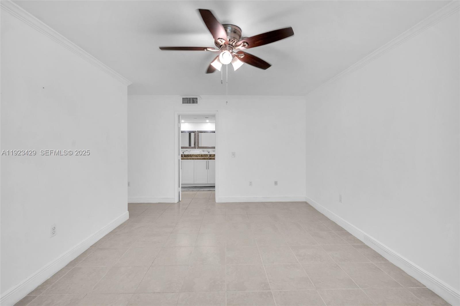 701 Southwest 142nd Avenue, Unit 414S Pembroke Pines, FL 33027 - Photo 24 of 30 an empty room with closet and ceiling fan