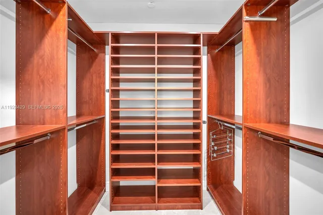 a view of walk in closet with empty racks