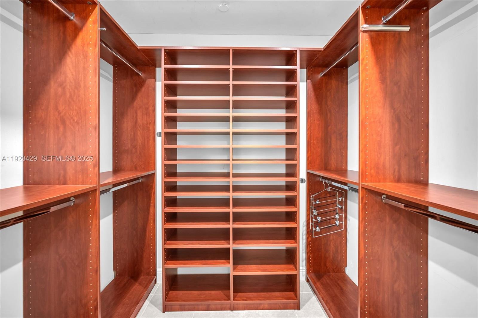 701 Southwest 142nd Avenue, Unit 414S Pembroke Pines, FL 33027 - Photo 25 of 30 a view of walk in closet with empty racks